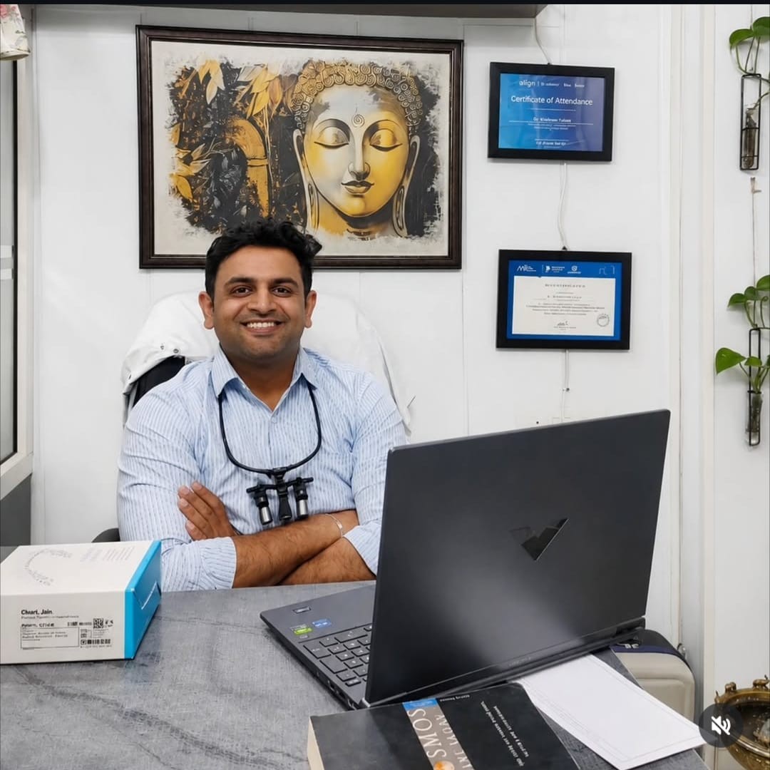 Dr. KrishanPal Yadav in white dental coat with stethoscope standing in modern dental clinic